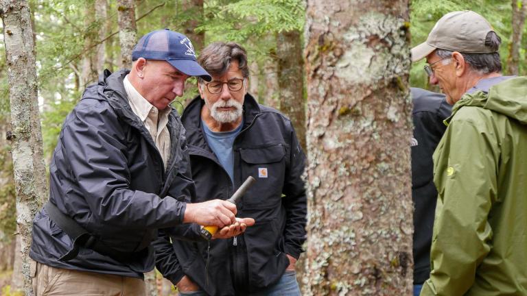 Gary Drayton holding up a find for the Lagina brothers to look at