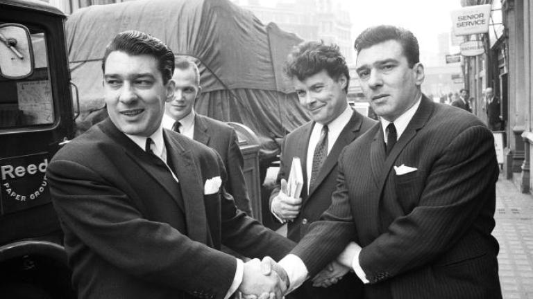 Ronnie and Reggie Kray lock hands as they celebrate being acquitted
