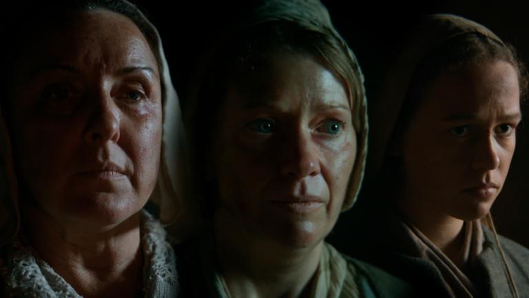 Three female actors portraying 16th and 17th century witches