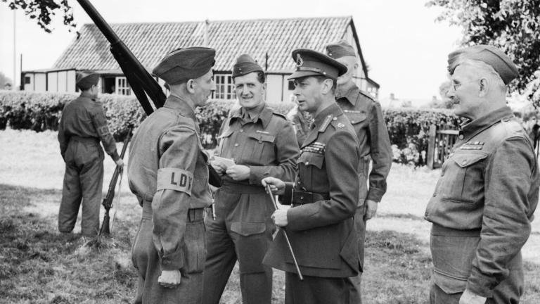 King George VI talking to a member of the Home Guard still wearing the LDV brassard, in August 1940
