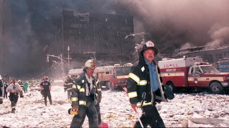 New York City firefighters walk near the area known as Ground Zero after the collapse of the Twin Towers