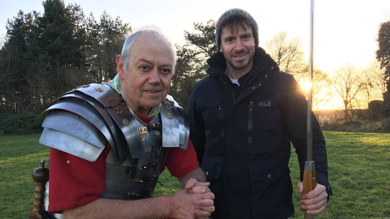 Rob Bell stood with a re-enactor and holding a large spear