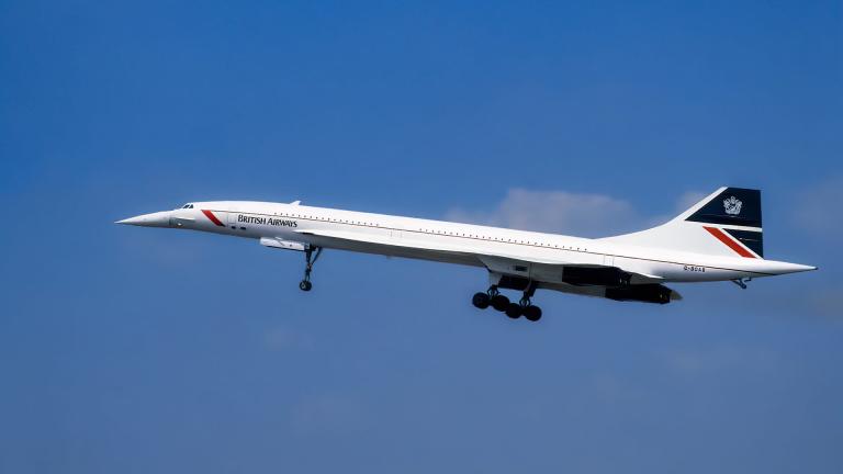 A Concorde plane belonging to British Airways taking off against a blue sky