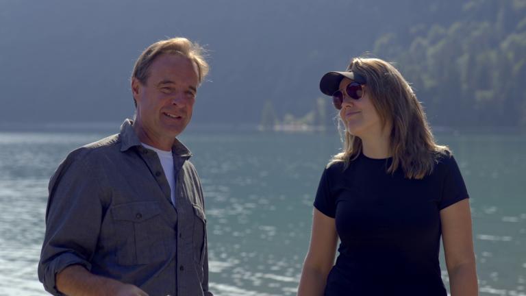 Guy Walters and Justine Ostrowska standing in front of a lake